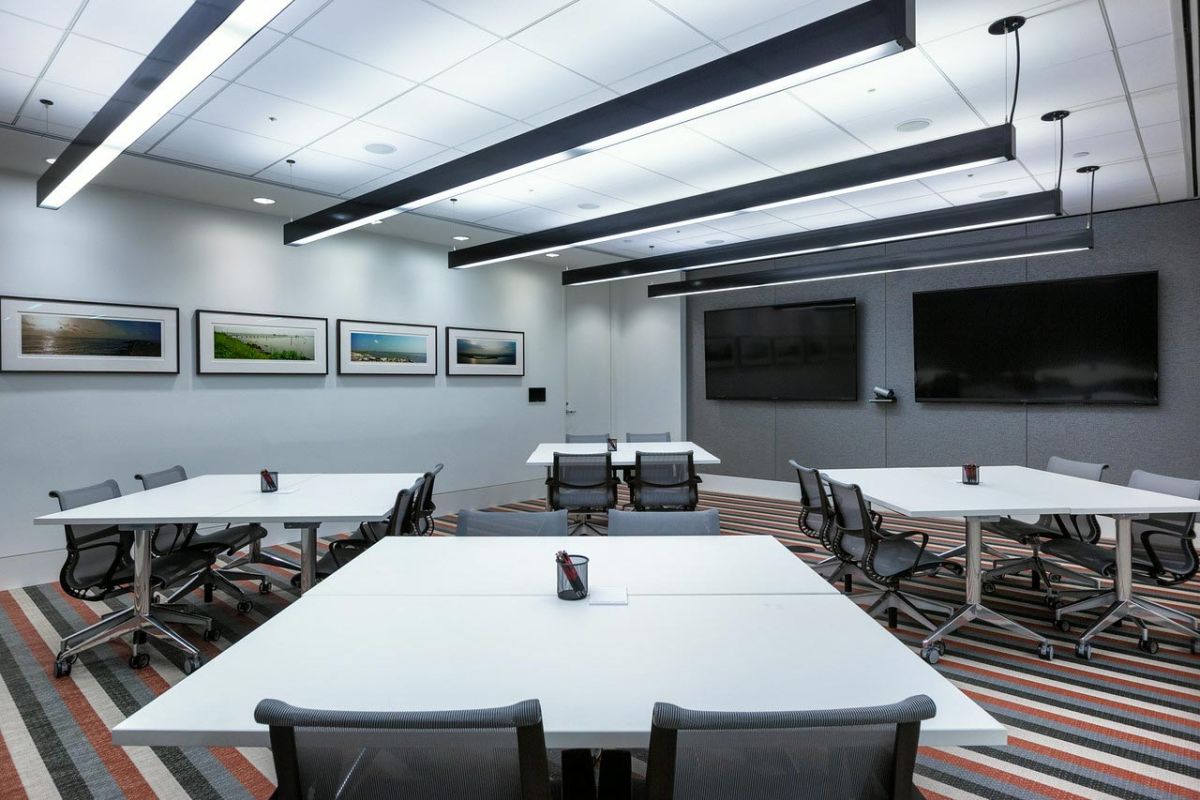 Modern conference room with white tables and striped carpet