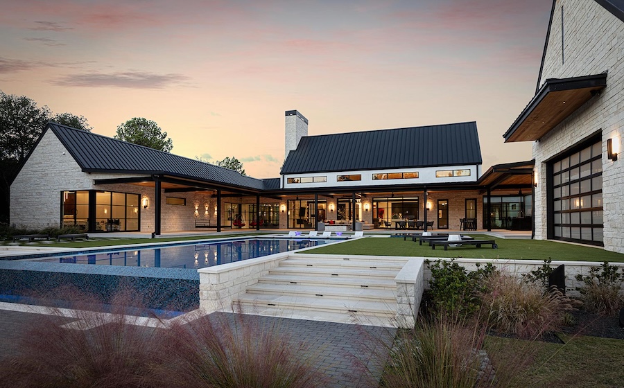 Backyard of a luxury estate. The pool and hardscape area features lighting and AV for premium entertainment.