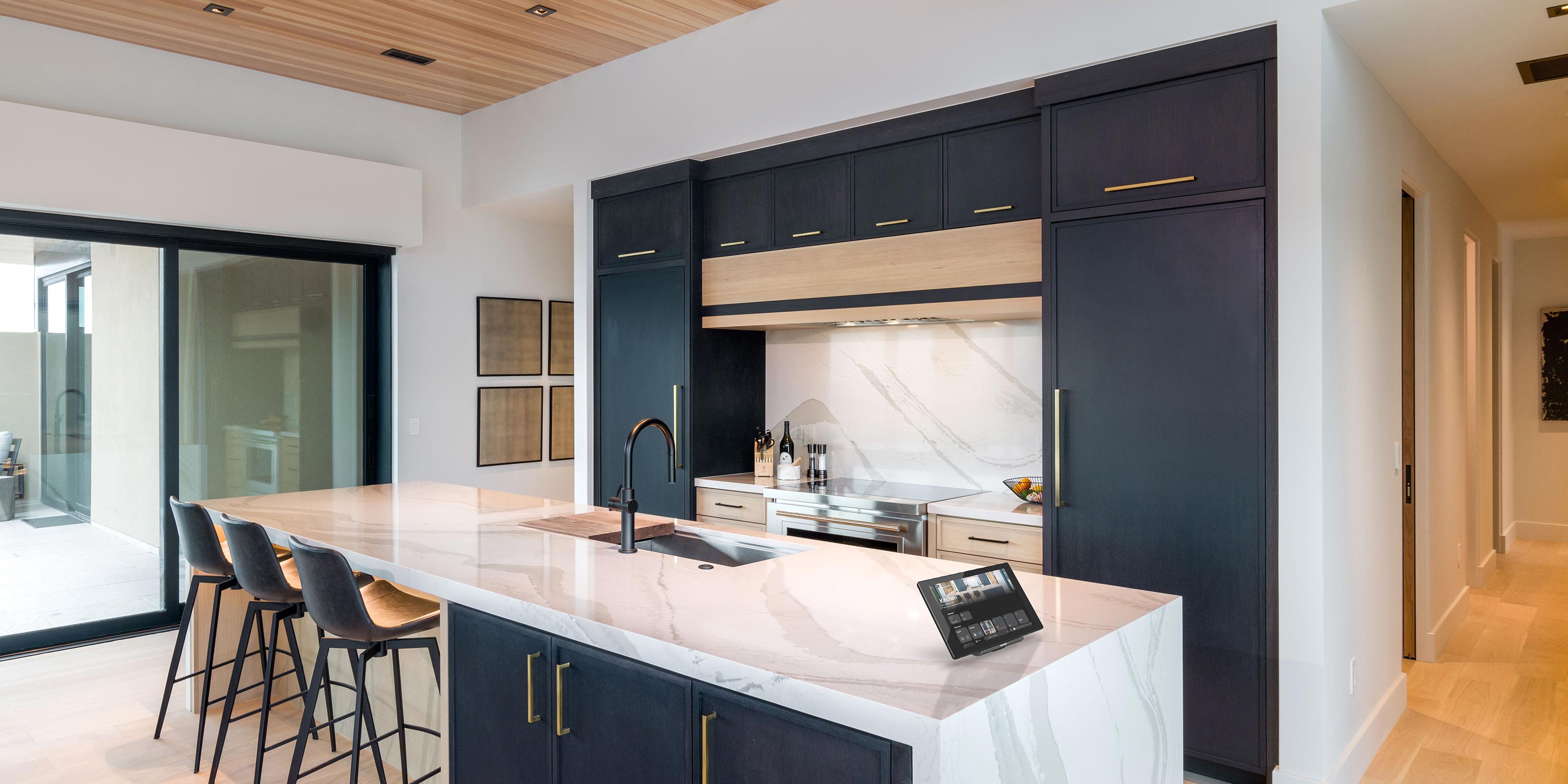 Contemporary kitchen with dark cabinets and a marble island