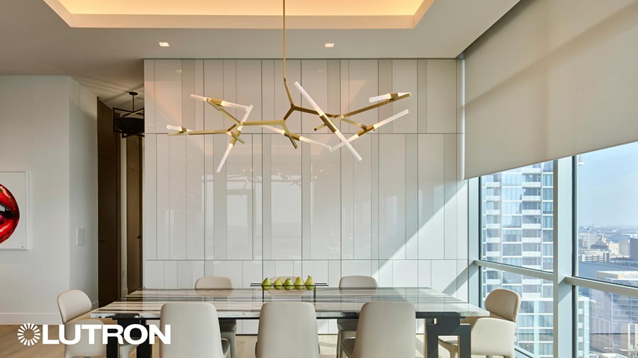 Elegant dining area with motorized Lutron shades and modern chandelier