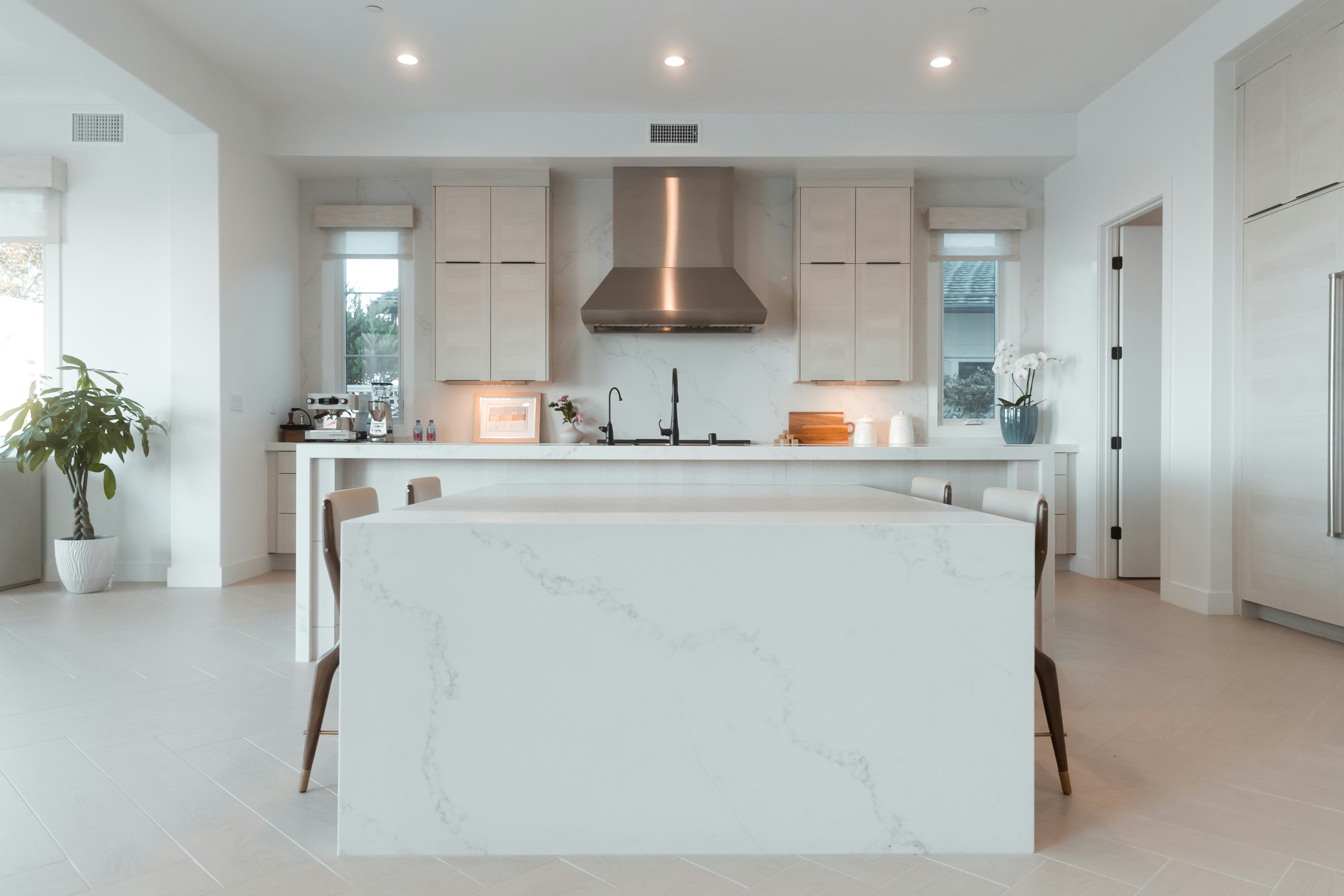 Elegant dining area with motorized Lutron shades and modern chandelier