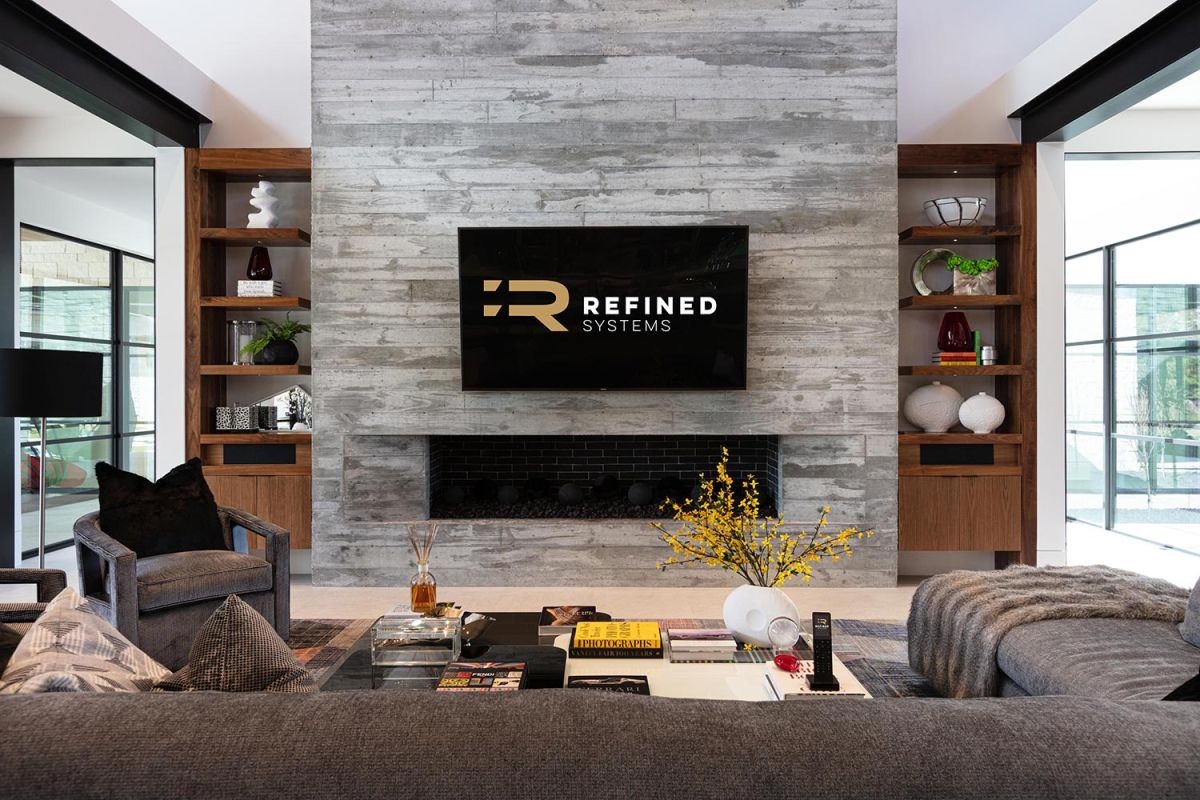 Stone fireplace with TV and built-in shelves in a modern living room
