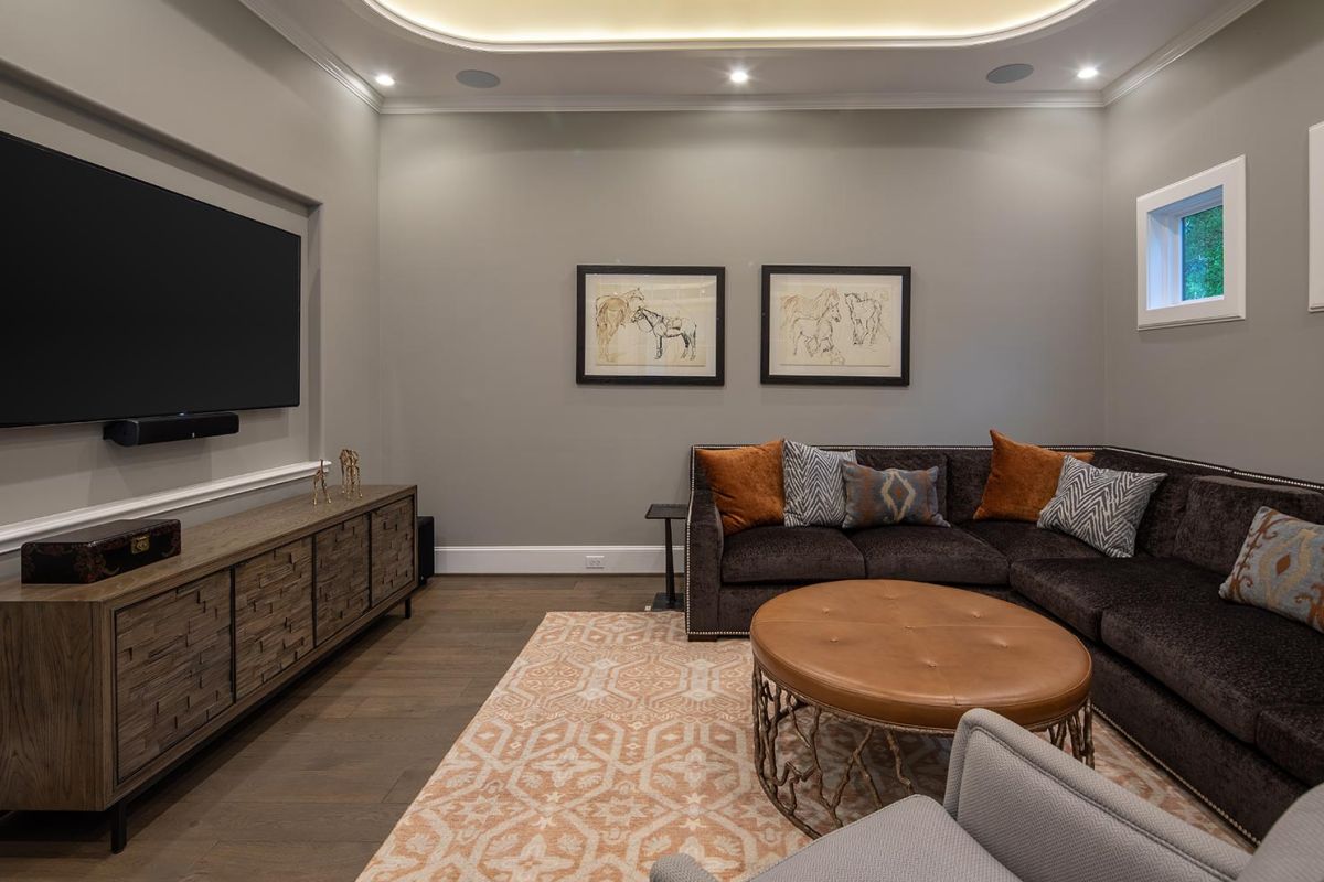 Cozy media room with sectional sofa and wall-mounted TV
