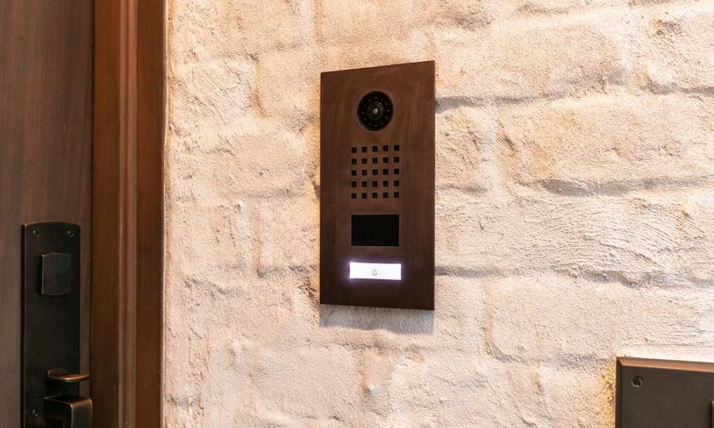 <span class="uk-h4">metallic finish door entry station by the front door of a residence.</span>