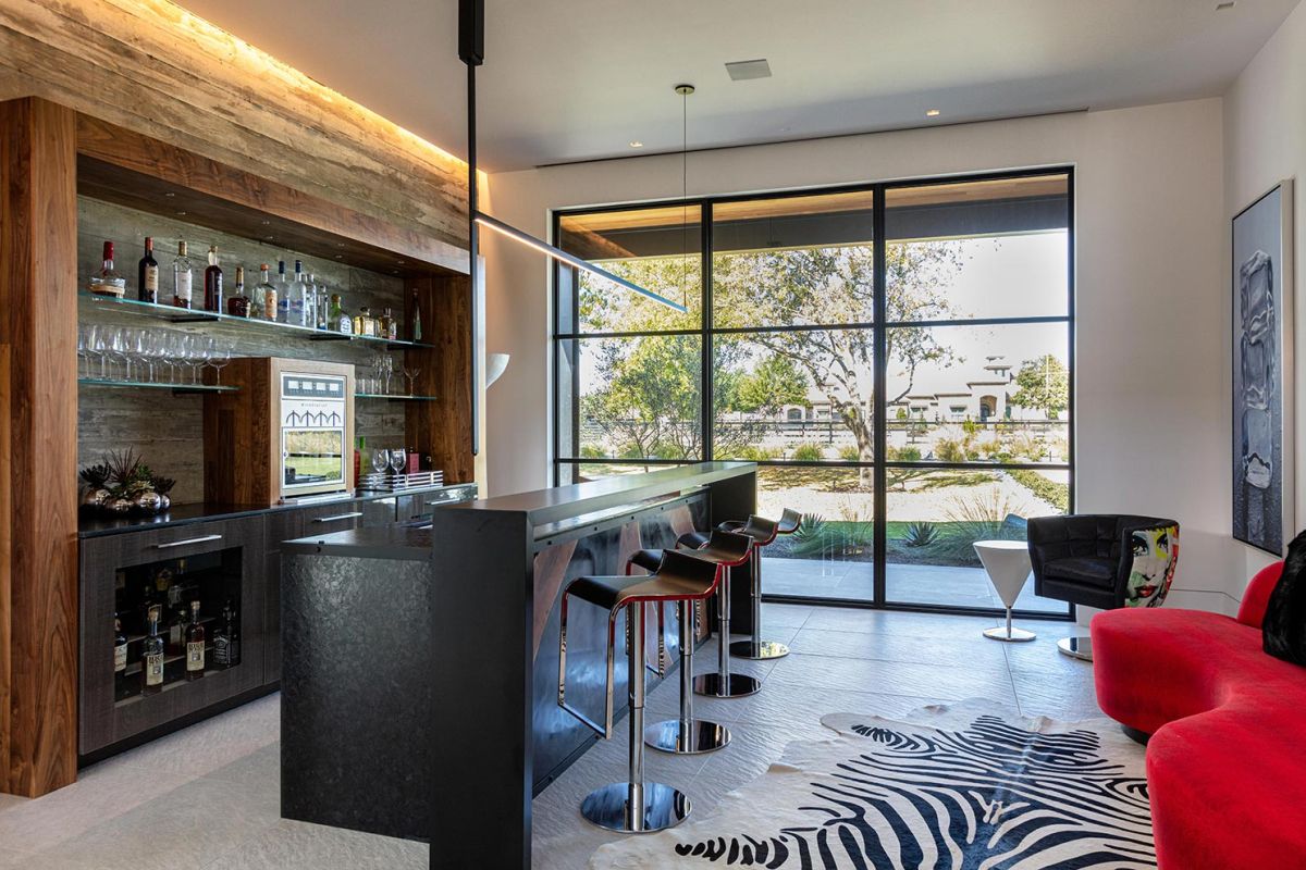 Home bar with wood and metal finishes and zebra print rug