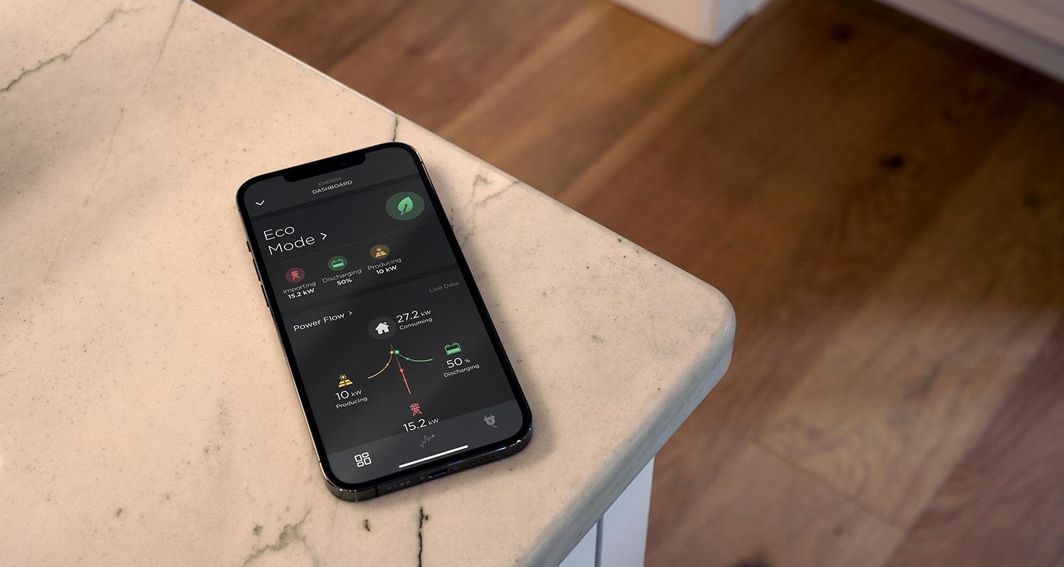 Smartphone with an energy dashboard placed on a kitchen counter
