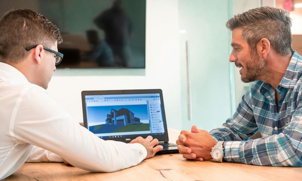 <span class="uk-h4">Integrator and homeowner reviewing a 3D home design on a laptop during a technology consultation.</span>