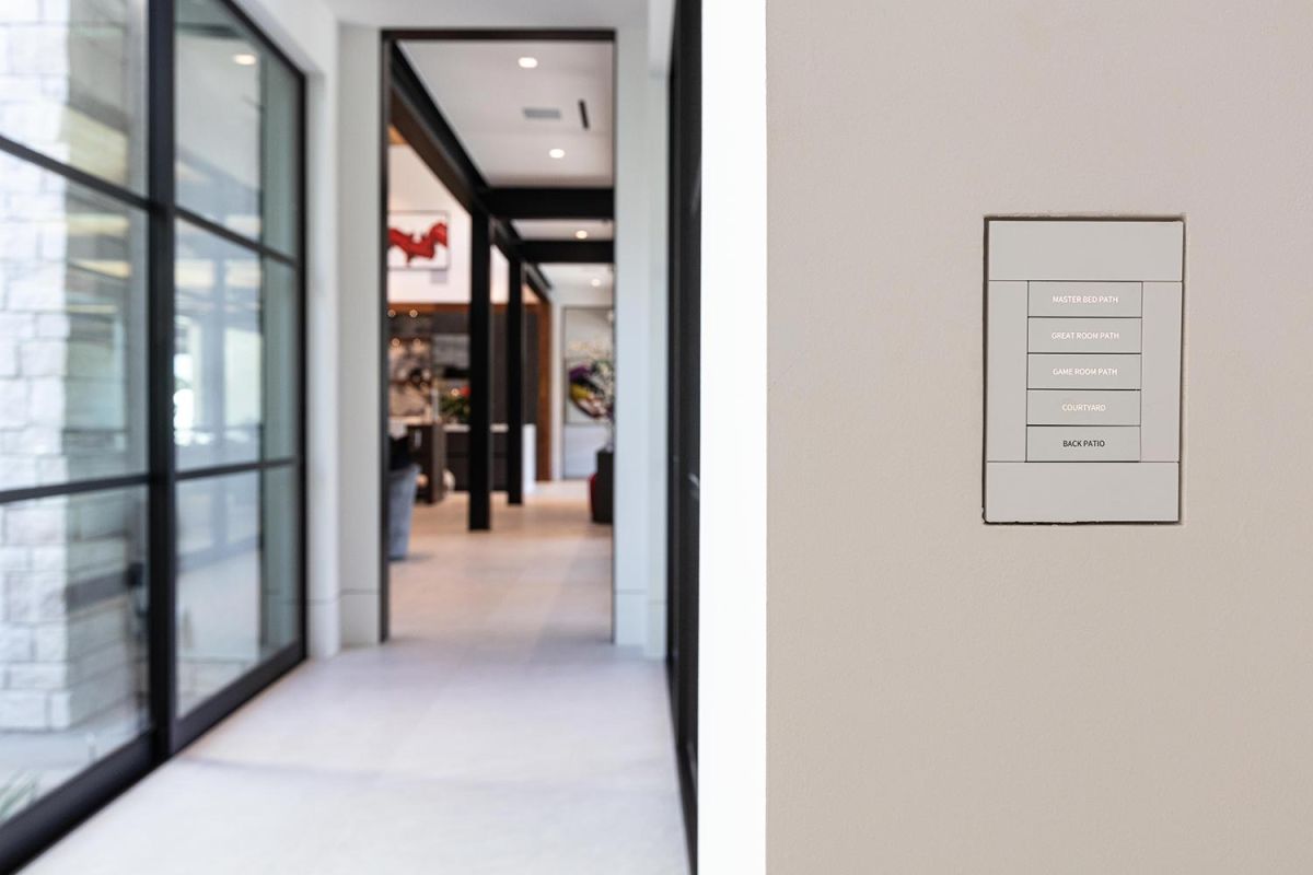 Light switch panel in hallway with labeled room paths