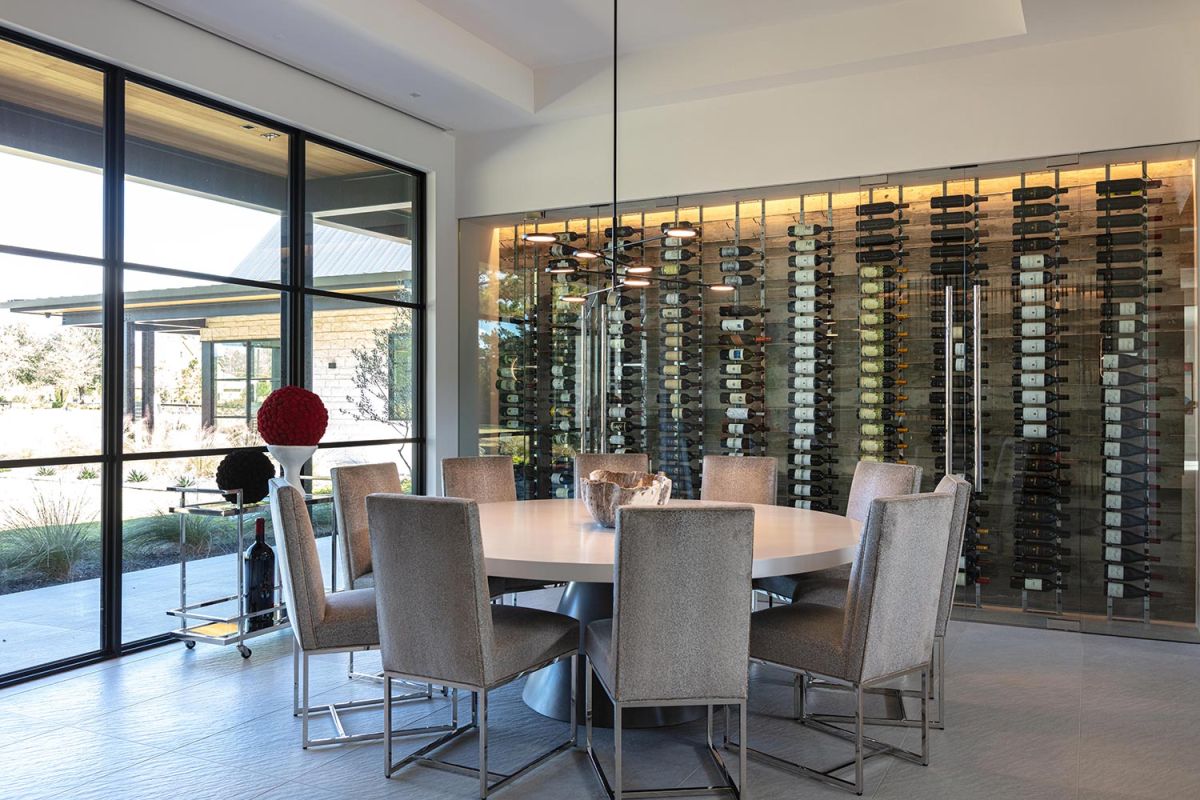 Wine room with glass wall and round dining table