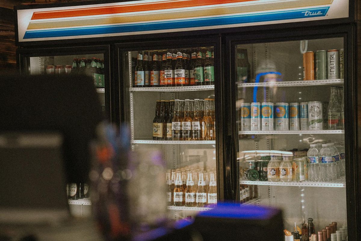 Close-up of a bar fridge filled with bottled and canned drinks