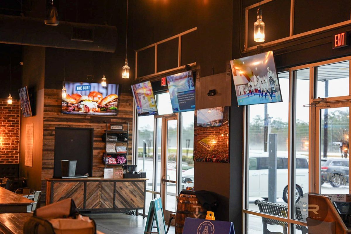 TVs near the bar entrance showing a mix of sports and promotional content.