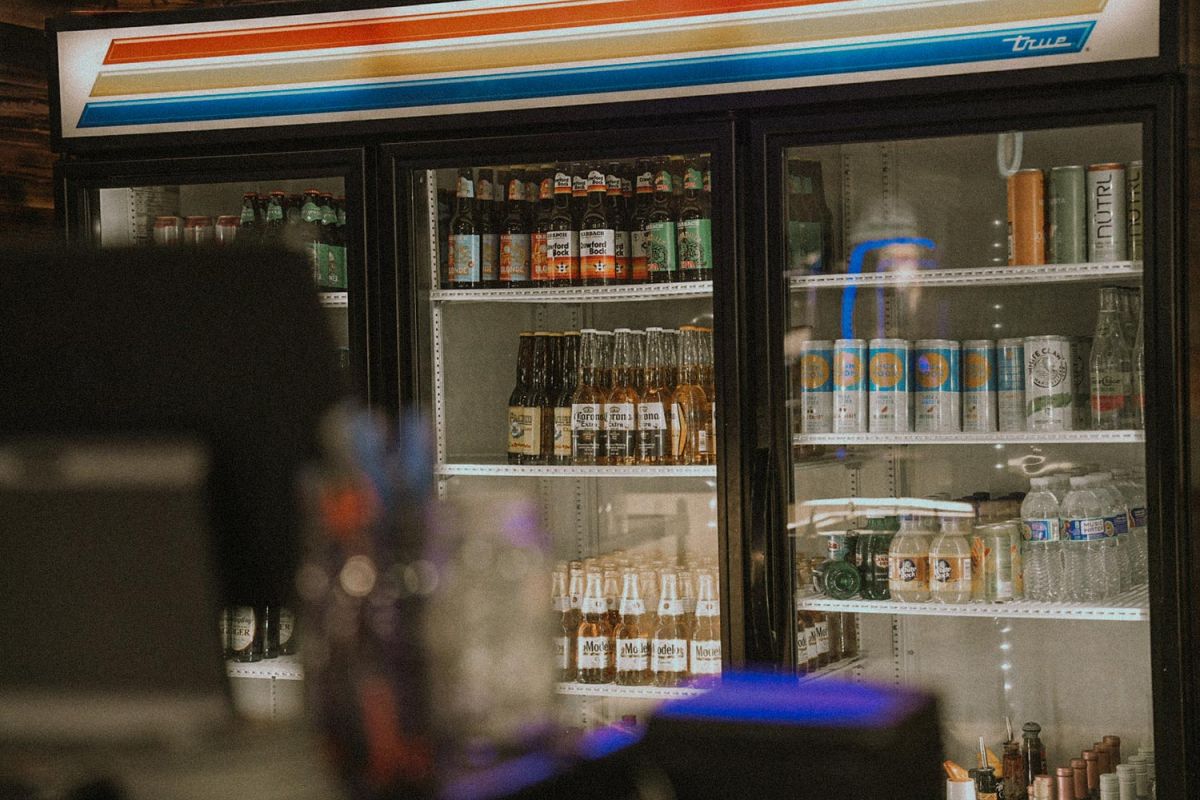 Close-up of a bar fridge filled with bottled and canned drinks